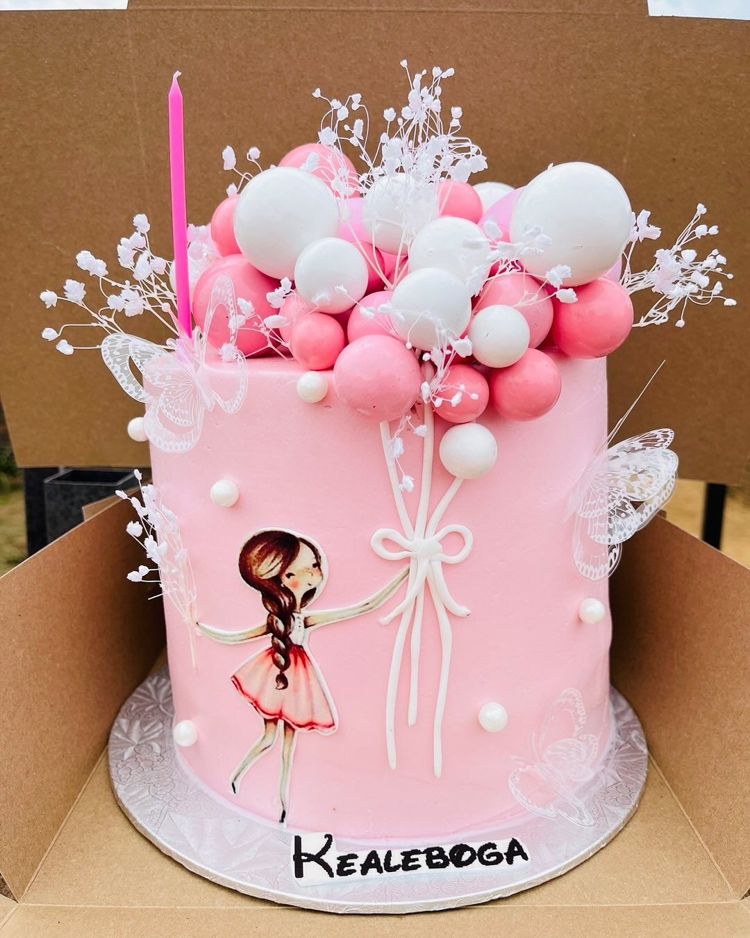 A pink balloon celebration cake by Baked by Buhlenkosi