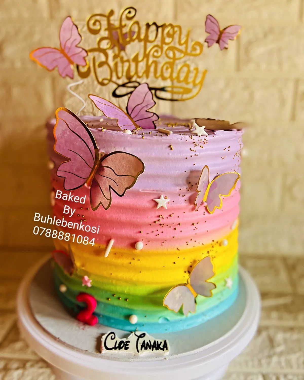 A pink ombré butterfly celebration cake by Baked by Buhlenkosi